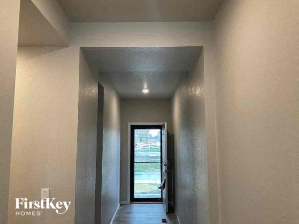 a hallway with a door and a light on the ceiling