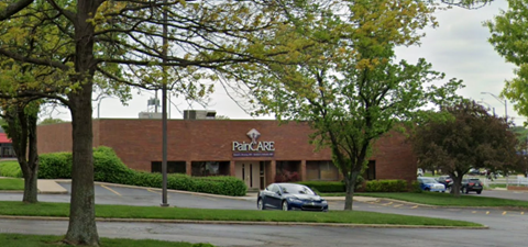 a parking lot with a car parked in front of a building