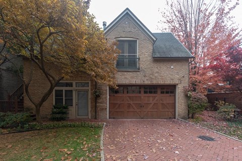a brick house with a driveway and a garage door