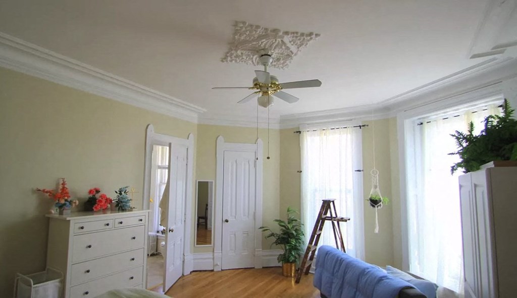 a view of a living room with a ceiling fan