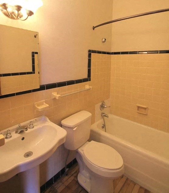 a white bathroom with a toilet and a sink