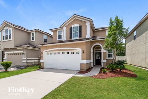 a beige house with a white garage door