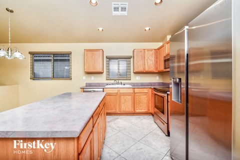 a kitchen with wooden cabinets and stainless steel appliances
