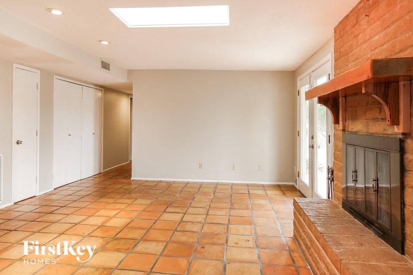 a living room with a fireplace and a tile floor