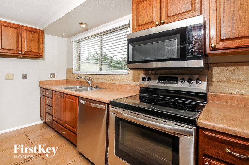 a kitchen with stainless steel appliances and wooden cabinets