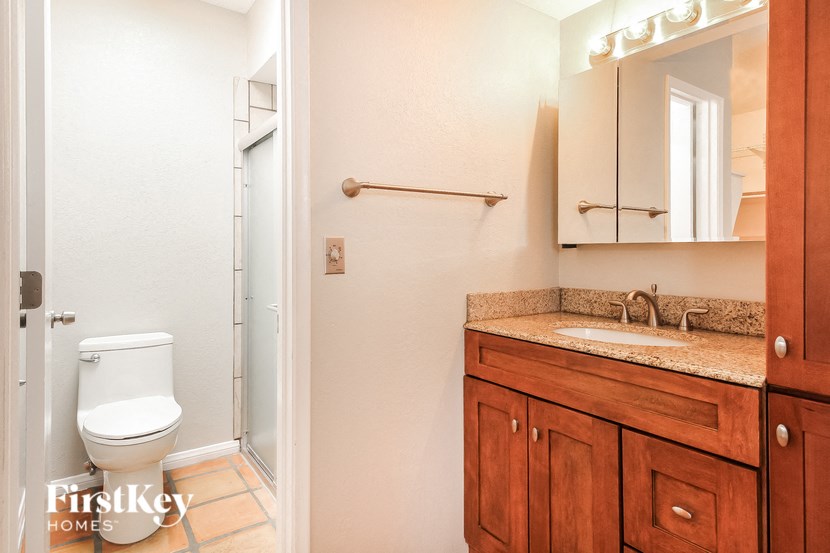 a bathroom with a toilet and a sink and a mirror