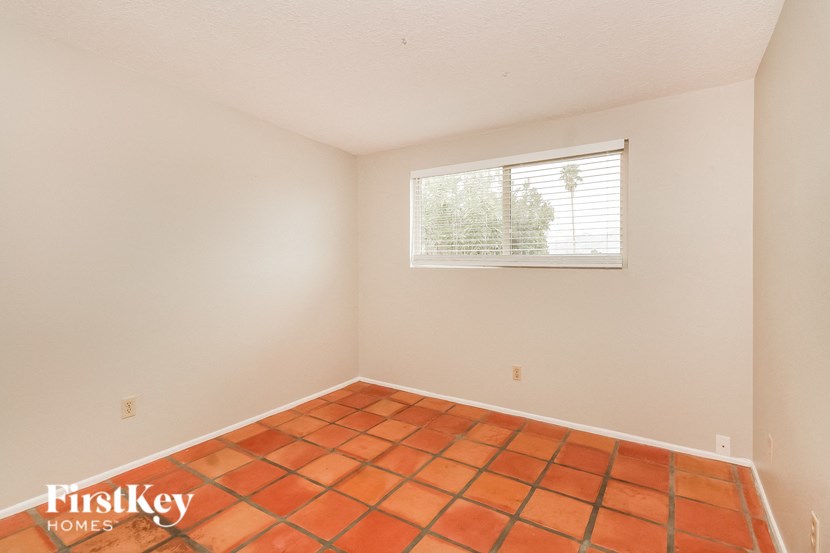 the living room of a home with a tile floor and a window