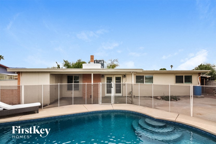 a pool in front of a house with a pool