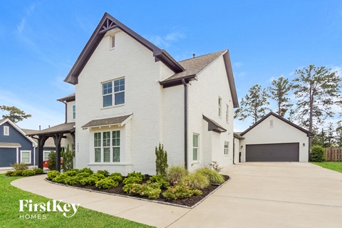 a white house with white siding and a garage