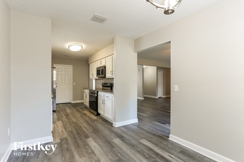 a renovated kitchen and living room with wood flooring
