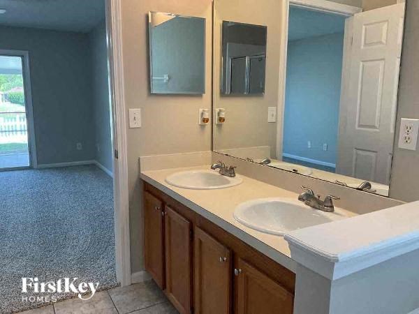 a bathroom with two sinks and a large mirror