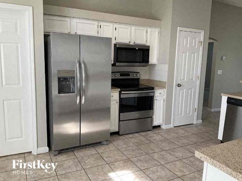 a kitchen with stainless steel appliances and white cabinets