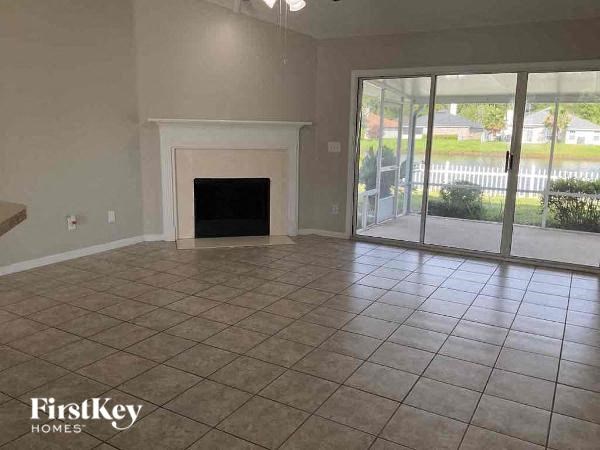 an empty living room with a fireplace and a sliding glass door