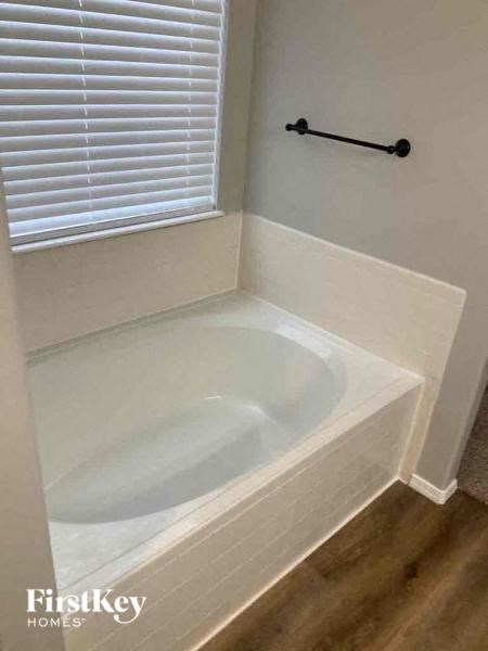 a bathroom with a bath tub and a window