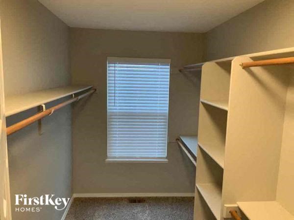 a small room with some shelves and a window