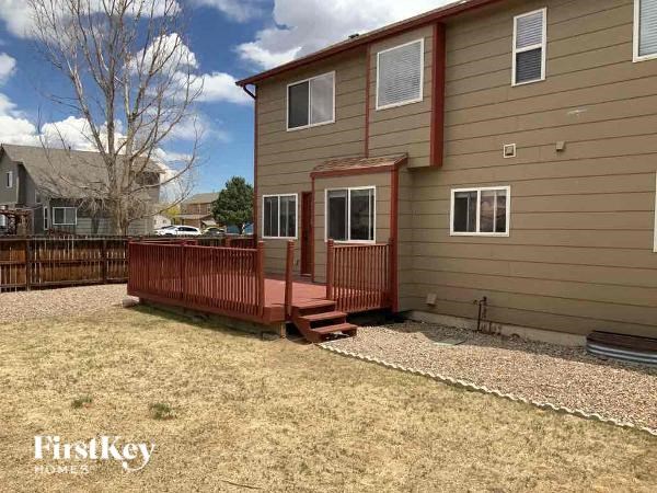 a house with a wooden deck in the yard