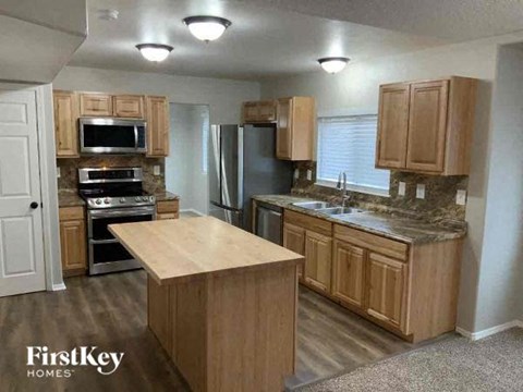 a kitchen with wooden cabinets and stainless steel appliances