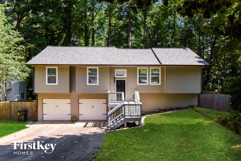 A two-story house with a garage and a porch.