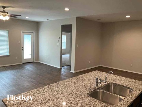 A kitchen with a granite countertop and a sink.