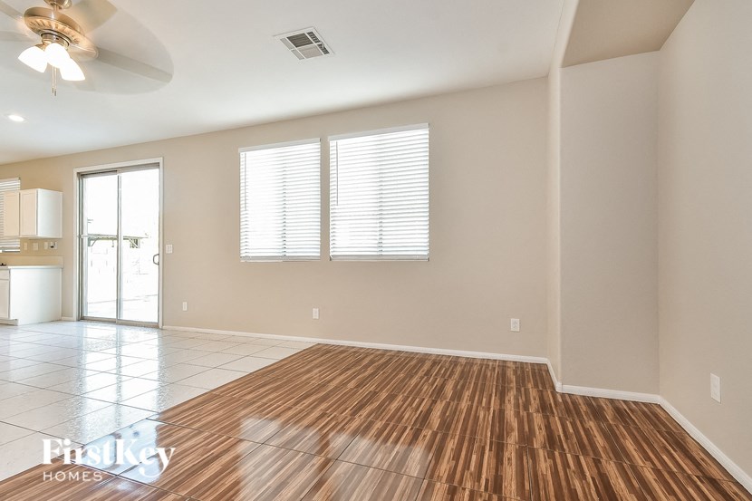 an empty living room with a wooden floor and a window