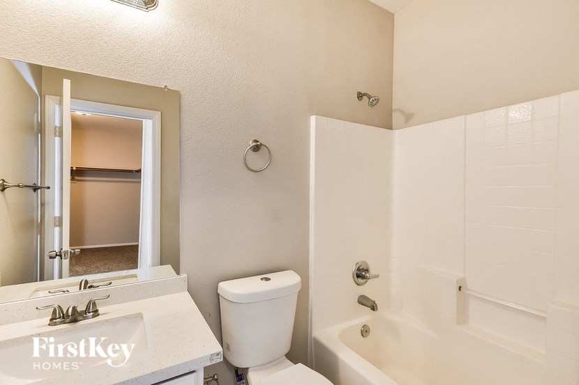 a bathroom with a tub and a toilet and a sink