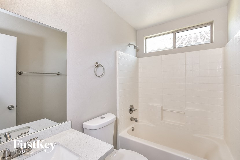 a bathroom with a tub and a sink and a toilet