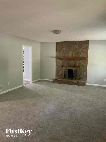 A room with a fireplace and a window.