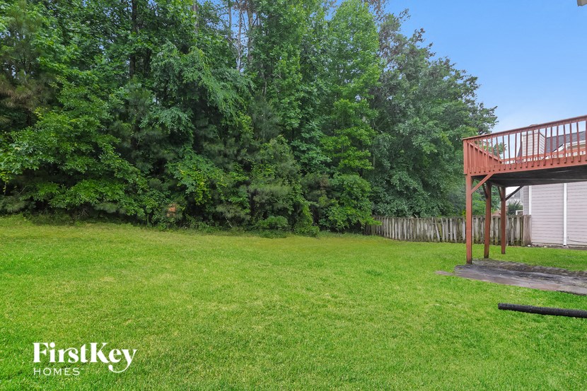a backyard with a deck and a garage