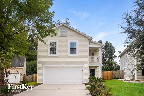 A two-story house with a garage is for sale.