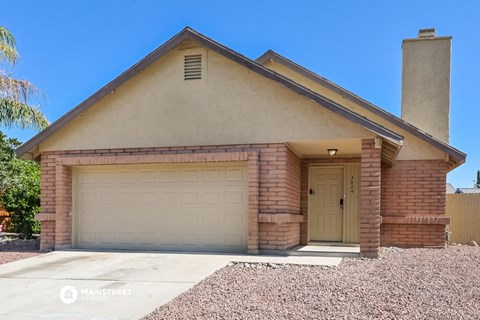 the front of a brick house with a garage door