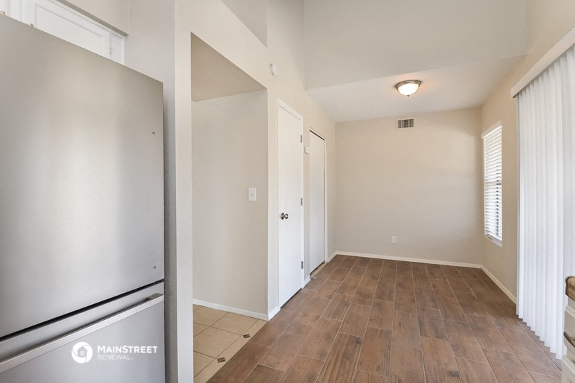the living room and dining room of an apartment