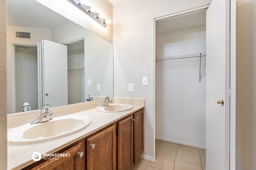 a bathroom with two sinks and a large mirror