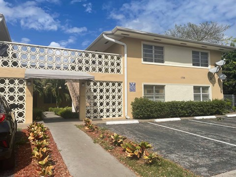 A building with a white gate and a sign that reads "1175" is shown.
