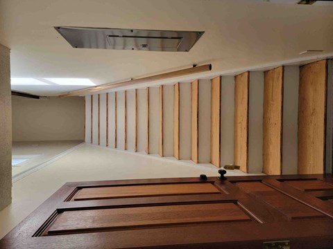 A long hallway with a row of wooden columns on the side.