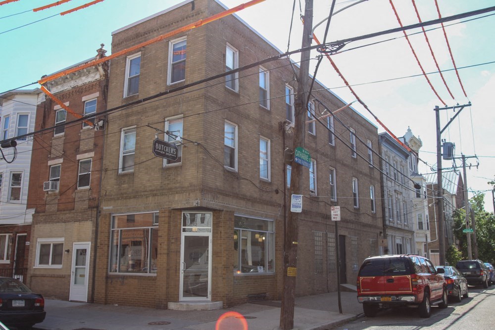 a brick building on the corner of a city street