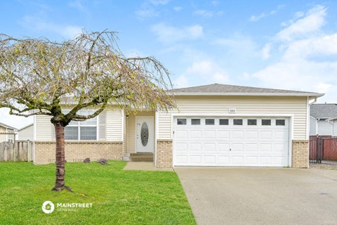 the front of a house with a white garage door