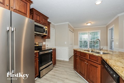 a kitchen with stainless steel appliances and wooden cabinets