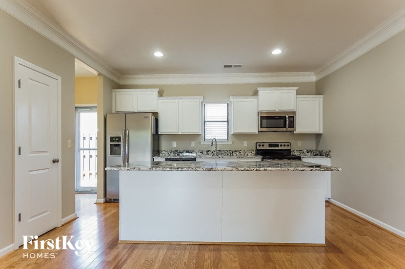 a kitchen with white cabinets and a counter top