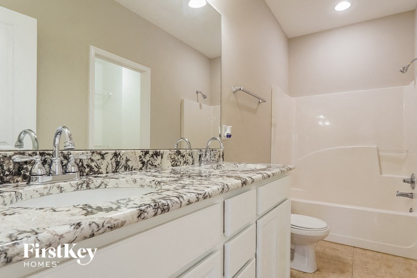 a bathroom with a sink and a toilet and a mirror