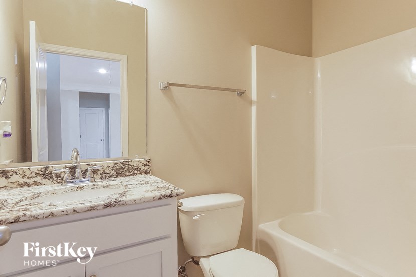 a bathroom with a toilet and a sink and a bath tub
