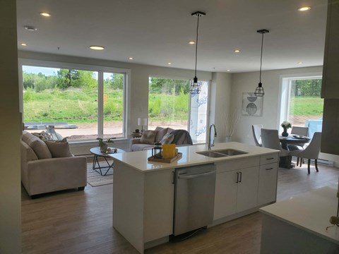 A modern kitchen with white cabinets and a large island.