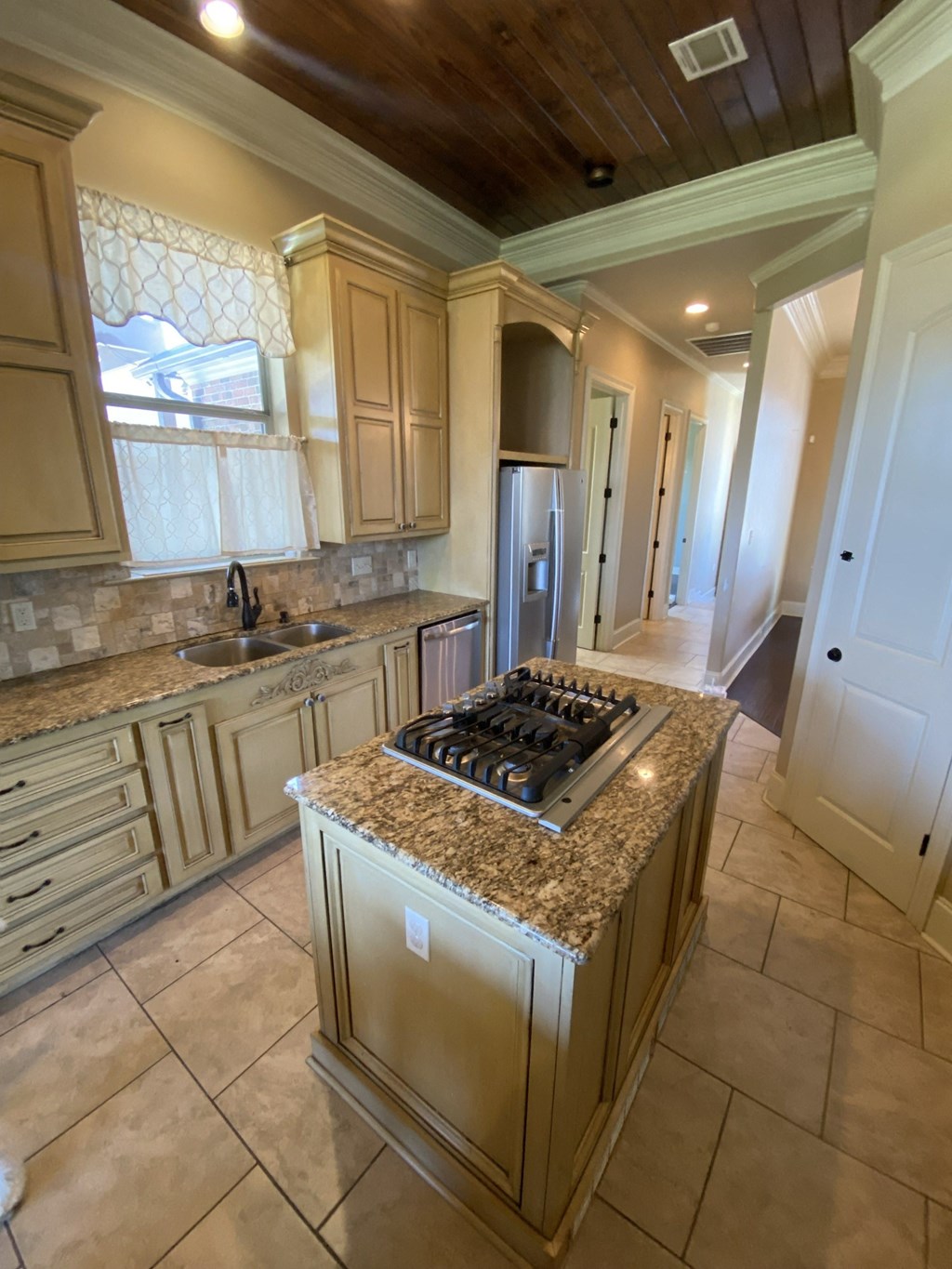 A kitchen with a granite countertop and a stove top oven.