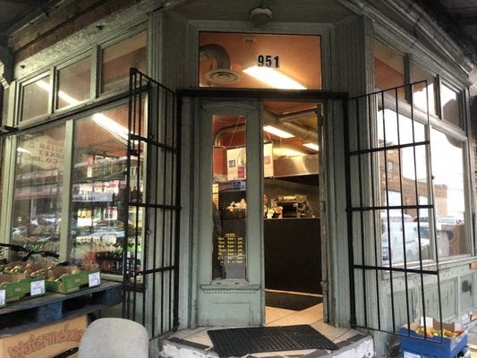 the front door of a store with bars around it