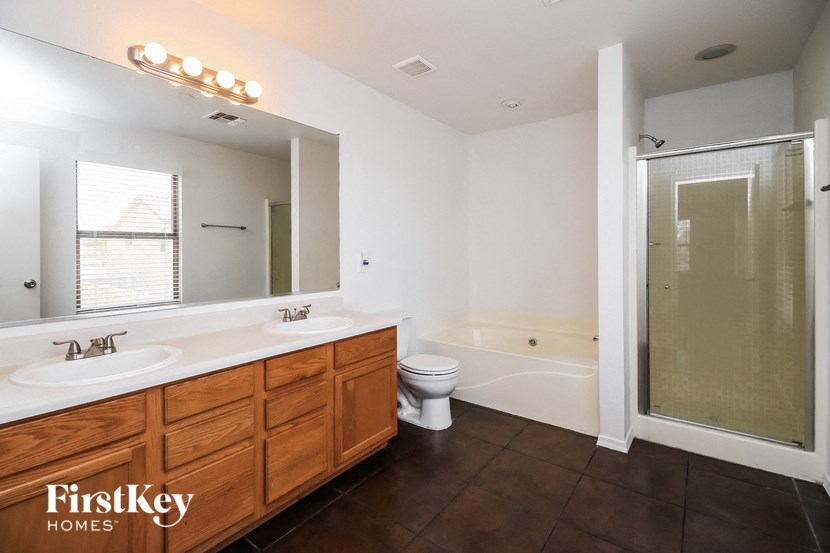 a bathroom with two sinks and a shower and a toilet