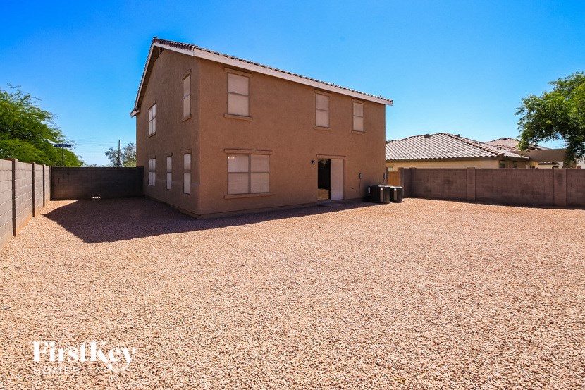 a house with a gravel driveway in front of it