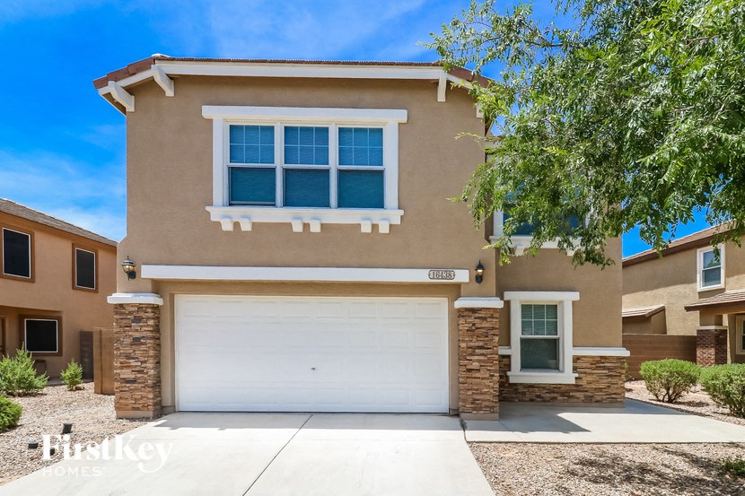 a beige house with a white garage door