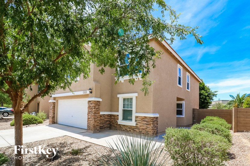 a house with a garage and a tree in front of it