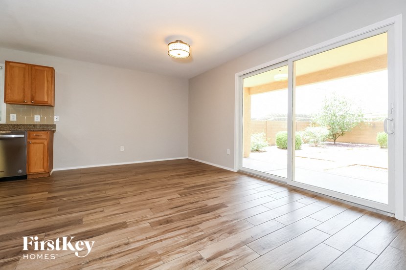 an empty living room with wood flooring and sliding glass doors