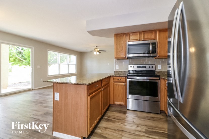 a kitchen with stainless steel appliances and wooden cabinets