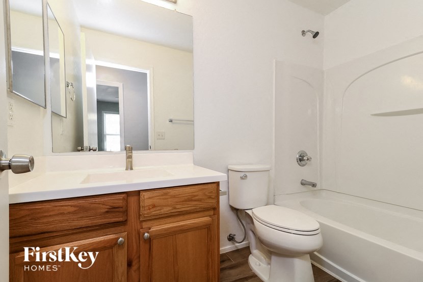 a bathroom with a sink toilet and a bath tub